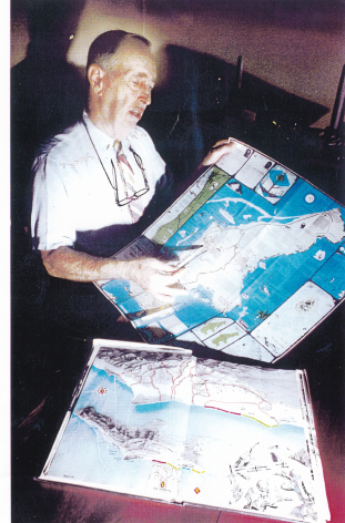 Robert Wallack recounts his remarkable experience on Saipan in 1944 as he reviews a map of the island for an with at his dining room table in Woodbridge, Conn., in 1990 shortly before his appearance on Unsolved Mysteries with Robert Stack. (Photo courtesy Michael O'Brien.)