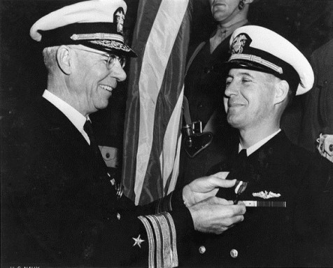 Rear Adm. Wilhelm L. Friedell, who commanded the USS Colorado as a captain in 1937, presents the Navy Cross to Lt. Cdr. W.M. Thomas, on dec. 7, 1942. Friedell's Navy career spanned 45 years, from 1901 to 1946, when he retired as a rear admiral, upper half.